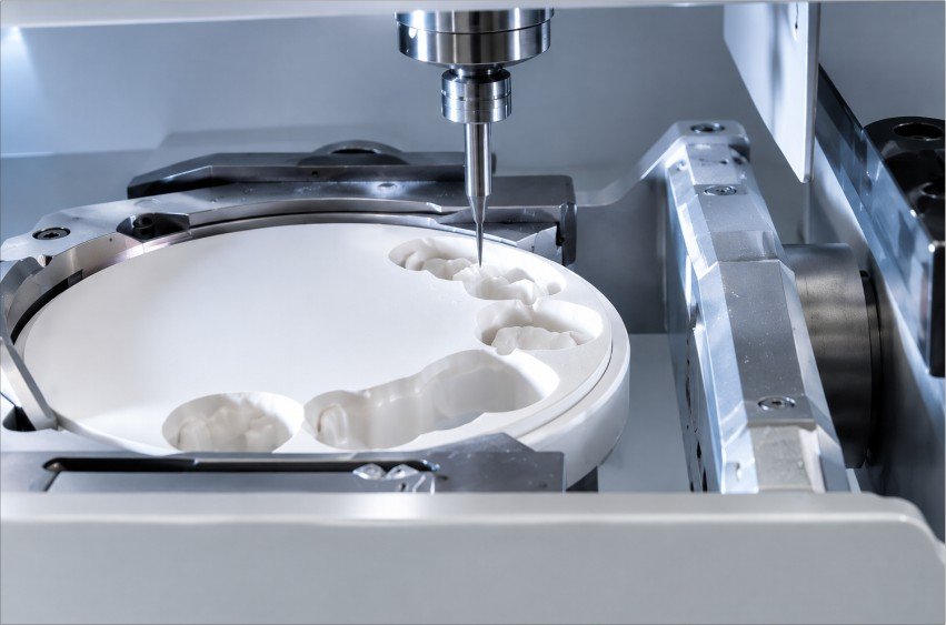 CAD CAM milling machine creating dental restoration
